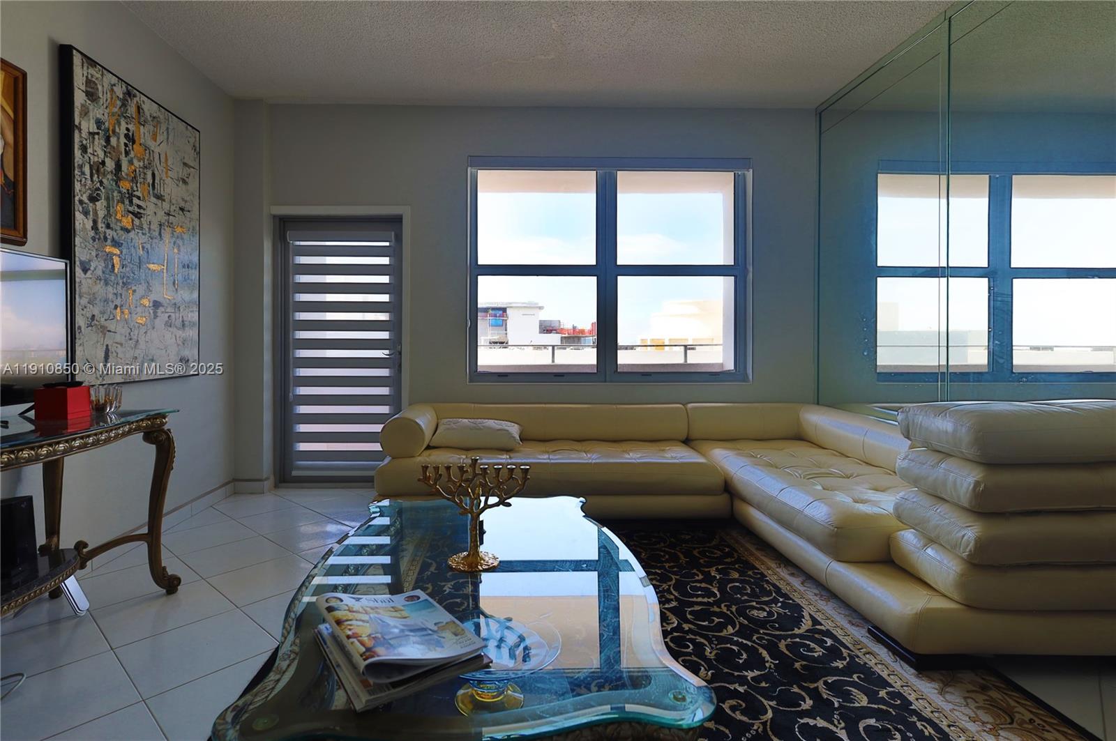 9225 Collins Avenue, Unit PHC Surfside, FL 33154 - Photo 25 of 33 a living room with furniture and a window