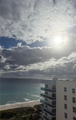 a spacious bedroom with a large bed and a large window