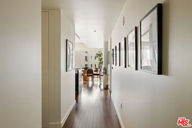 a view of a living room with furniture and wooden floor