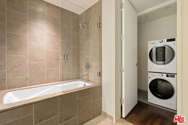 a bathroom with a tub a sink and a shower