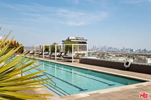 a view of a swimming pool with outdoor seating