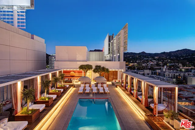 a living room with patio furniture and a pool table
