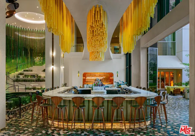 a view of a patio with table and chairs potted plants and a large tree