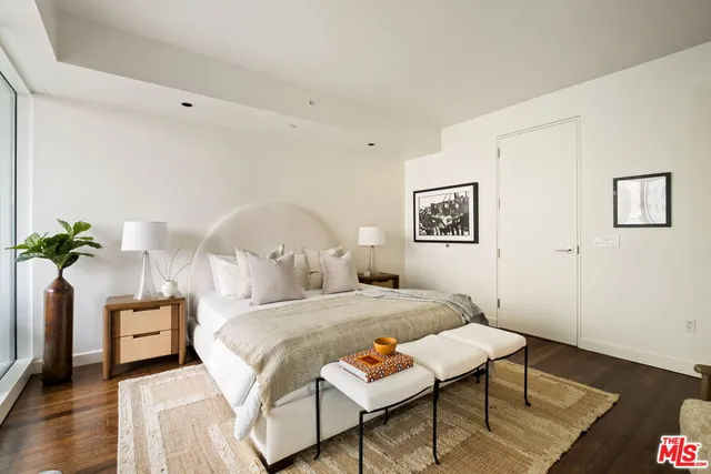 a bedroom with a bed and a potted plant