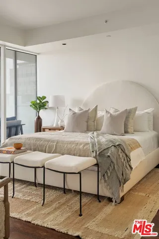 a living room with a couch and a potted plant