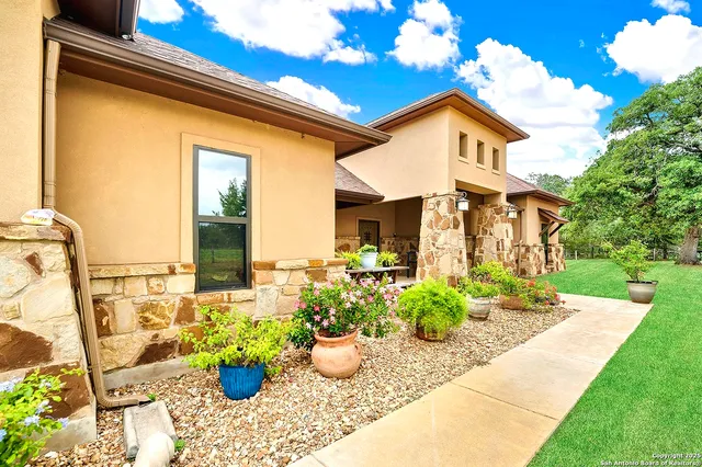 a front view of a house with outdoor seating