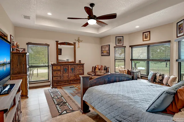 a bedroom with furniture and a large window