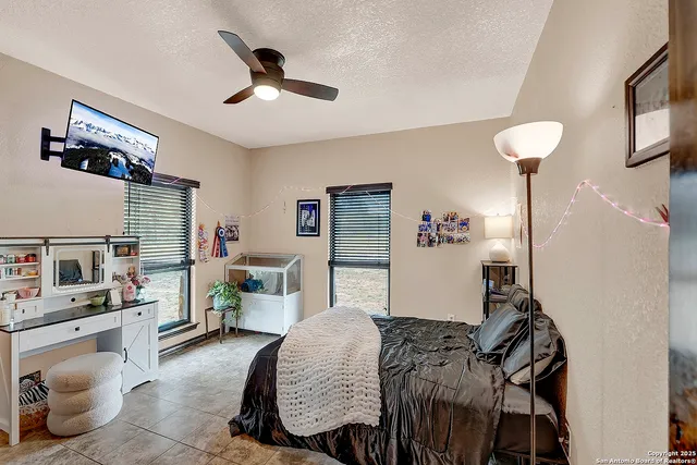 a bedroom with a bed wooden floor and window