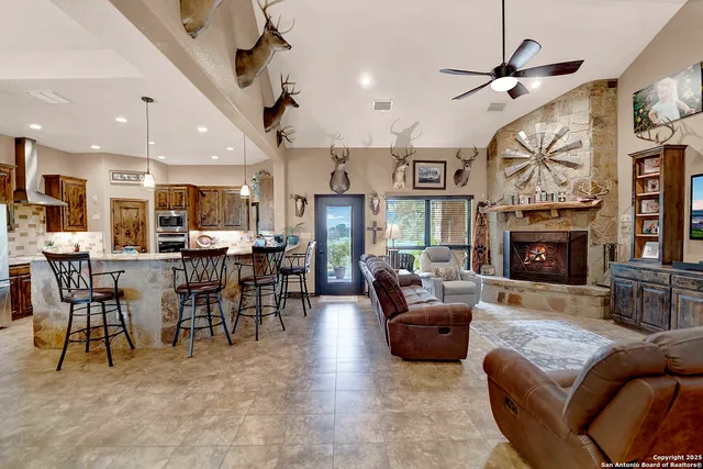a living room with furniture a fireplace and a flat screen tv