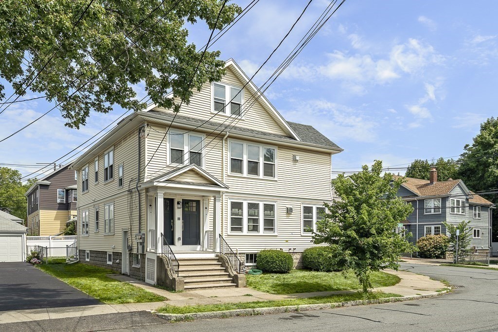 1 Mary Street, Unit 1 Arlington, MA 02474 - Photo 1 of 27 a front view of a house with a yard