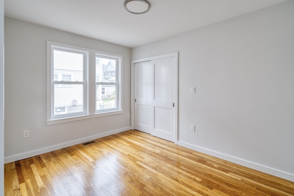 1 Mary Street, Unit 1 Arlington, MA 02474 - Photo 13 of 27 a view of an empty room with wooden floor and a window
