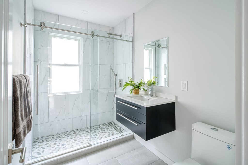 1 Mary Street, Unit 1 Arlington, MA 02474 - Photo 14 of 27 a bathroom with a shower sink and mirror