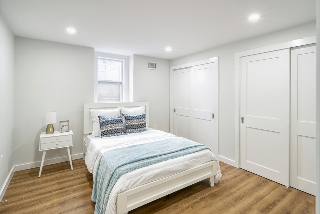 1 Mary Street, Unit 1 Arlington, MA 02474 - Photo 18 of 27 a bedroom with a bed and a window