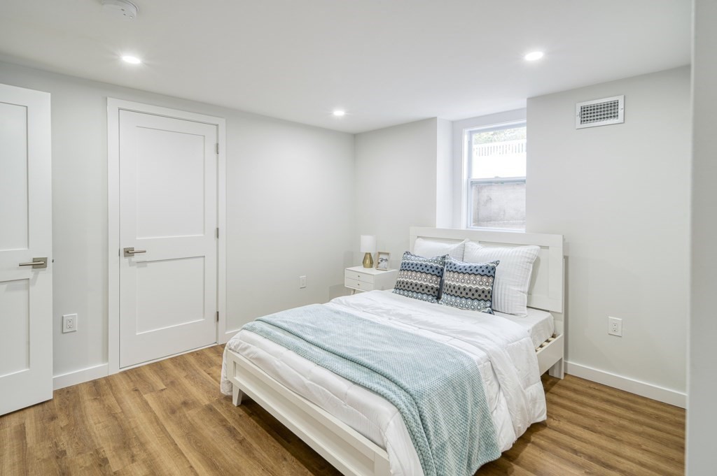 1 Mary Street, Unit 1 Arlington, MA 02474 - Photo 19 of 27 a bedroom with bed and window