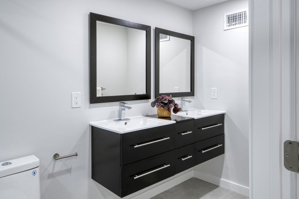 1 Mary Street, Unit 1 Arlington, MA 02474 - Photo 20 of 27 a bathroom with a toilet sink and mirror