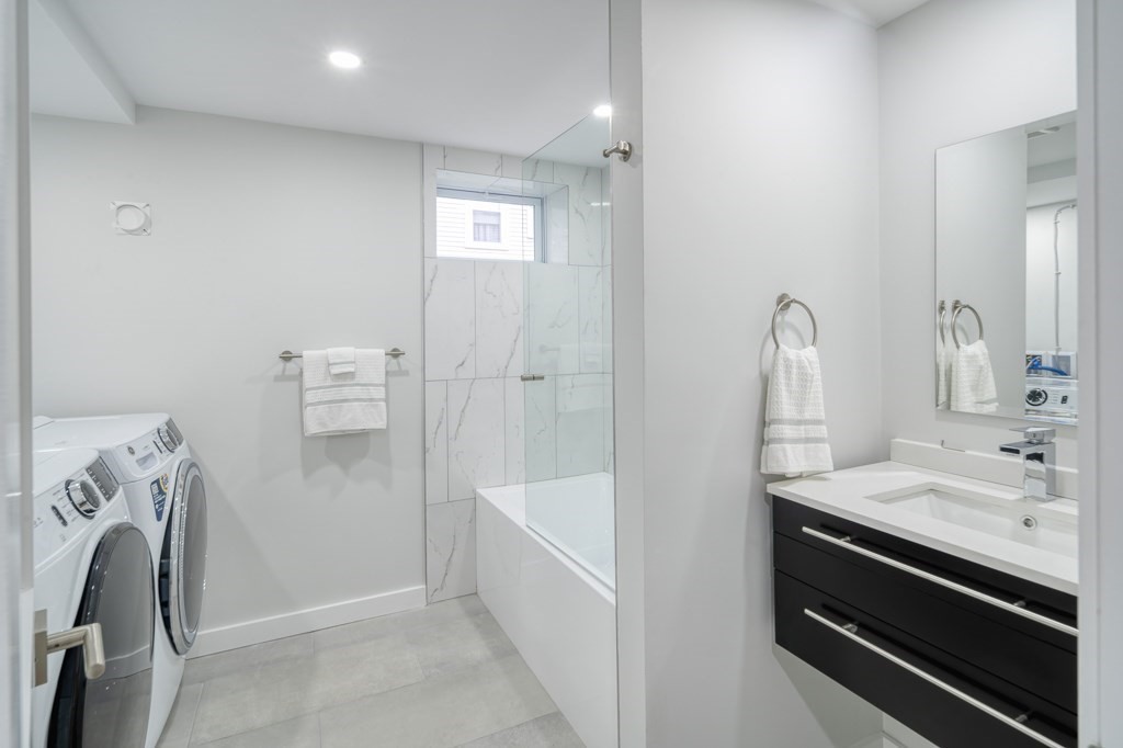 1 Mary Street, Unit 1 Arlington, MA 02474 - Photo 22 of 27 a bathroom with a sink a washer and dryer