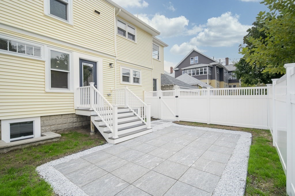 1 Mary Street, Unit 1 Arlington, MA 02474 - Photo 24 of 27 a view of a white house with a yard