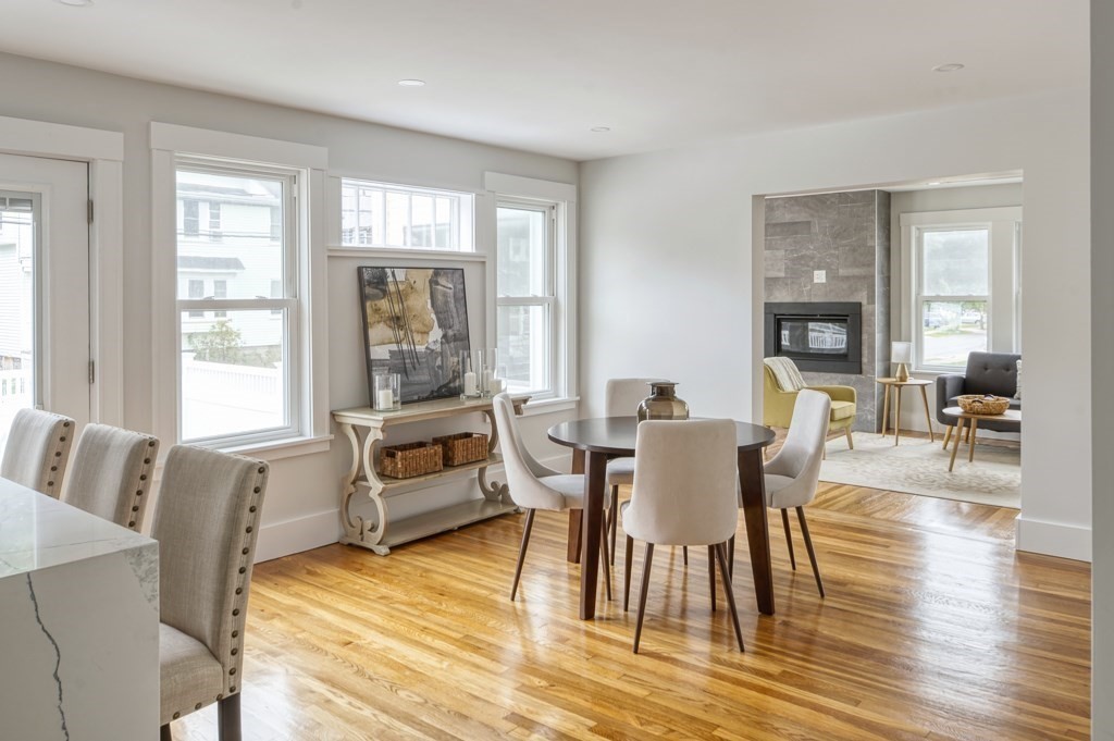 1 Mary Street, Unit 1 Arlington, MA 02474 - Photo 6 of 27 a dining room with wooden floor a glass table and chairs