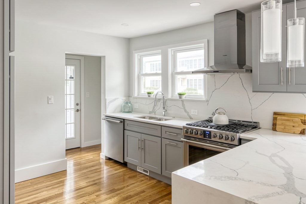 1 Mary Street, Unit 1 Arlington, MA 02474 - Photo 10 of 27 a kitchen with stainless steel appliances a sink stove and window