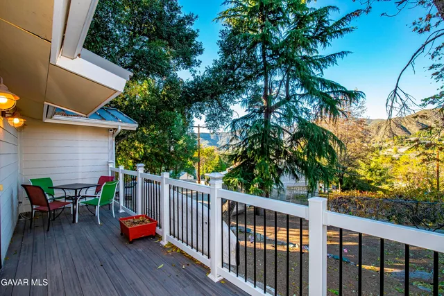 a view of deck with table and chairs and wooden floor