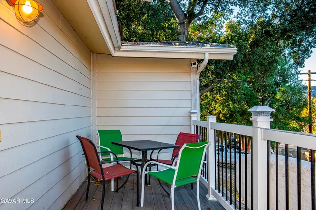 a backyard of a house with table and chairs