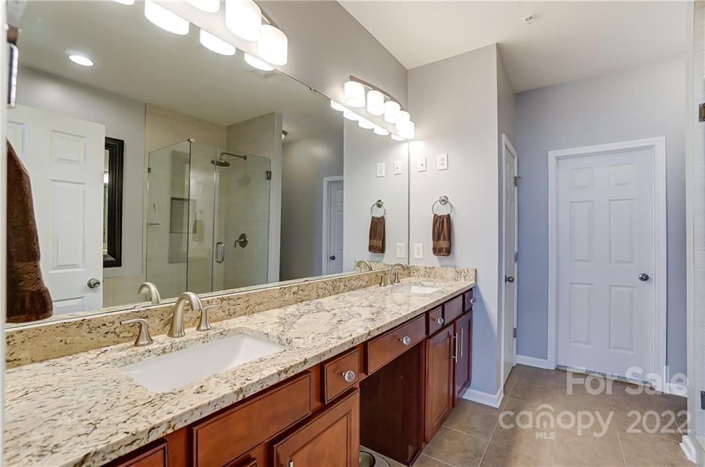 320 Wave Crest Drive Tega Cay, SC 29708 - Photo 24 of 46 a bathroom with a granite countertop double vanity sink and a mirror