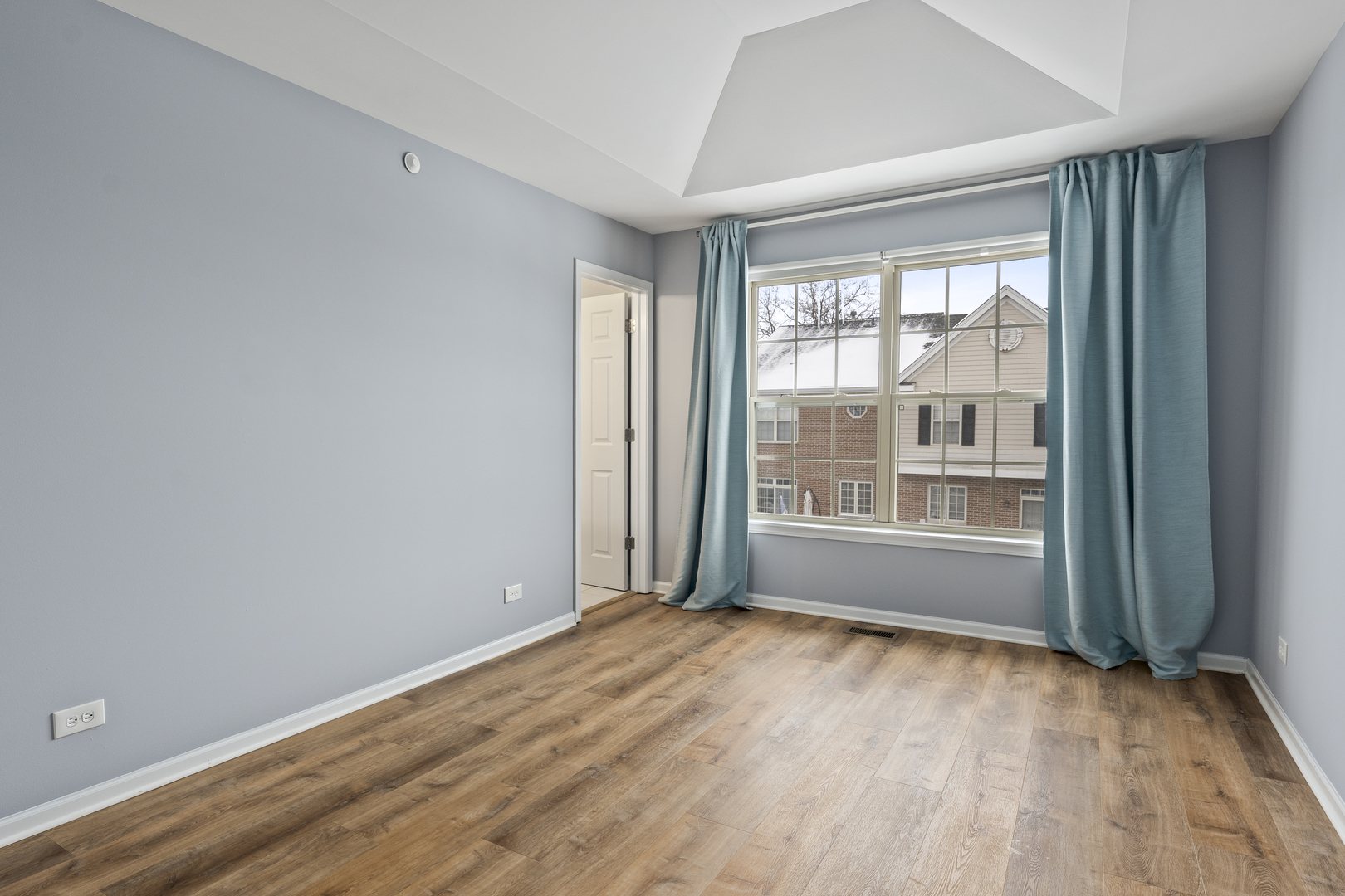 484 Prestwick Lane Wheeling, IL 60090 - Photo 16 of 36 a view of an empty room with wooden floor and a window