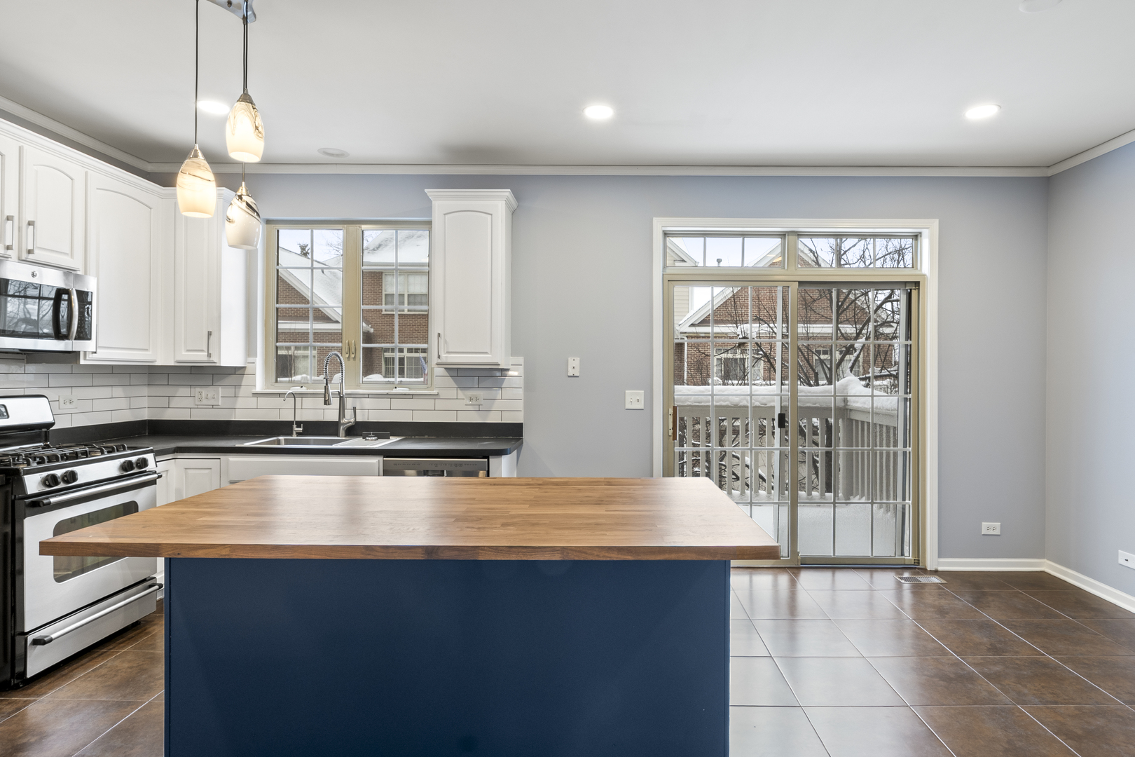 484 Prestwick Lane Wheeling, IL 60090 - Photo 8 of 36 a kitchen with stainless steel appliances granite countertop a sink window and cabinets