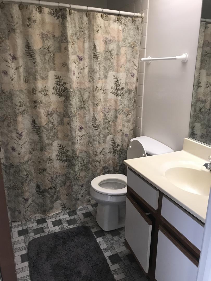 235 Monroe Road Bolingbrook, IL 60440 - Photo 14 of 25 a bathroom with a granite countertop toilet and a sink