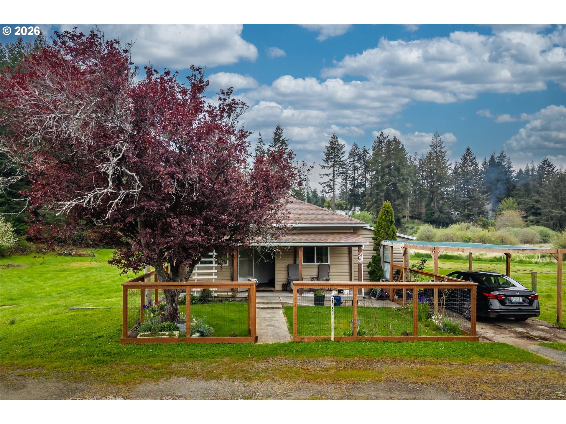 63008 Red Dyke Road Coos Bay, OR 97420 - Photo 1 of 18 a front view of a house with garden