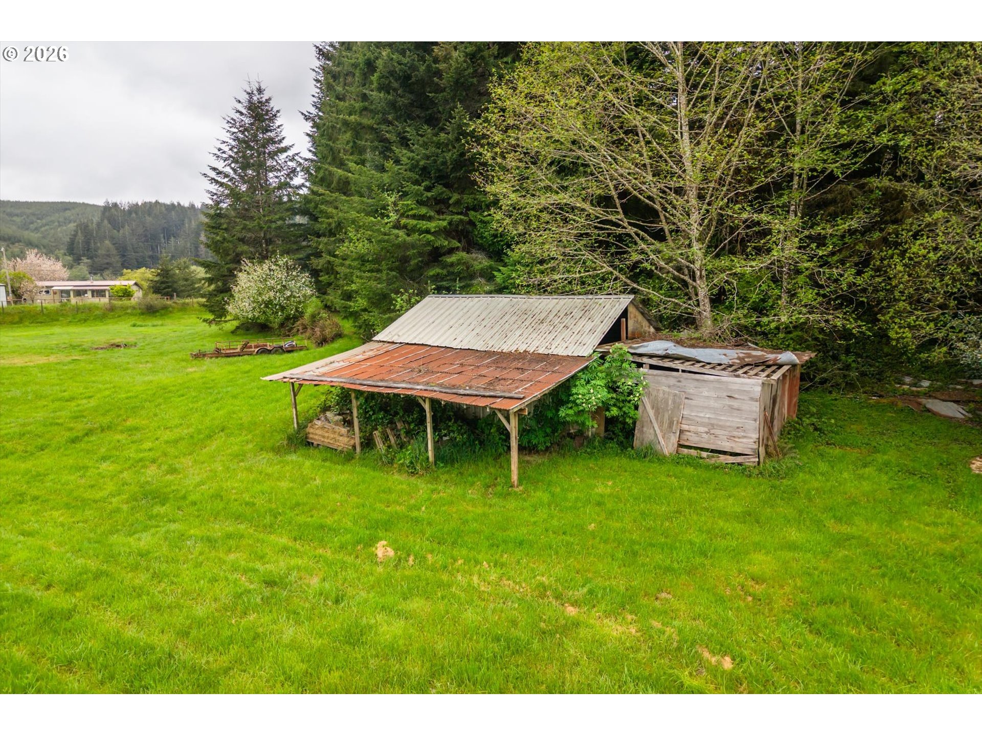 63008 Red Dyke Road Coos Bay, OR 97420 - Photo 17 of 18 a backyard of a house with table and chairs