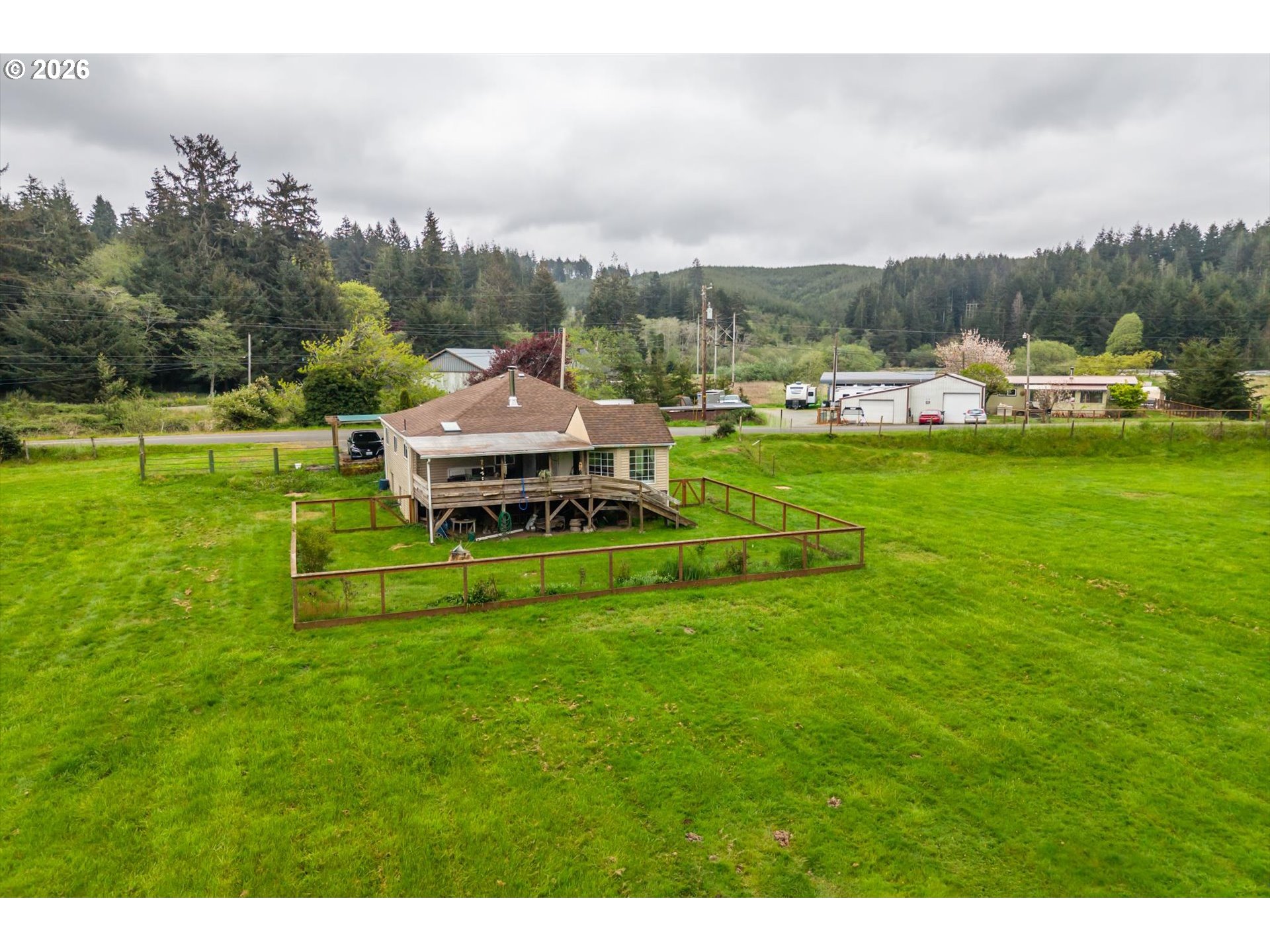 63008 Red Dyke Road Coos Bay, OR 97420 - Photo 8 of 18 a view of a big house with a big yard and large trees