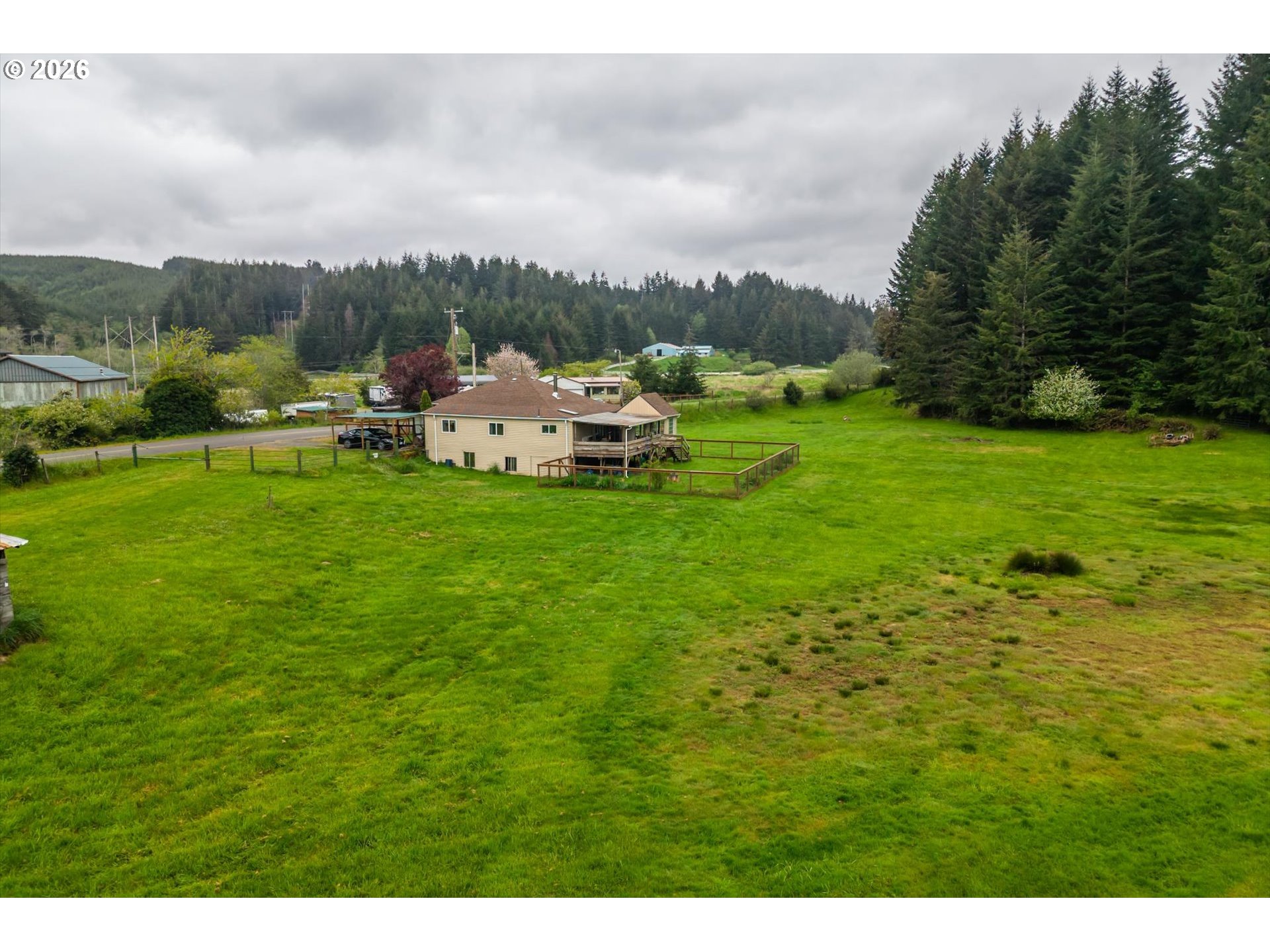 63008 Red Dyke Road Coos Bay, OR 97420 - Photo 9 of 18 a backyard of a house with table and chairs