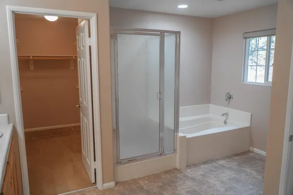 a bathroom with a bathtub and a shower
