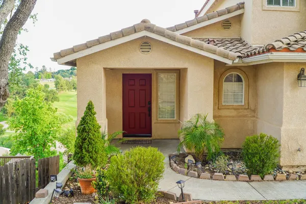 a front view of a house with garden