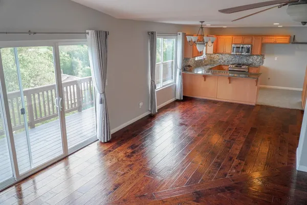 a kitchen with stainless steel appliances granite countertop a stove and a wooden floors