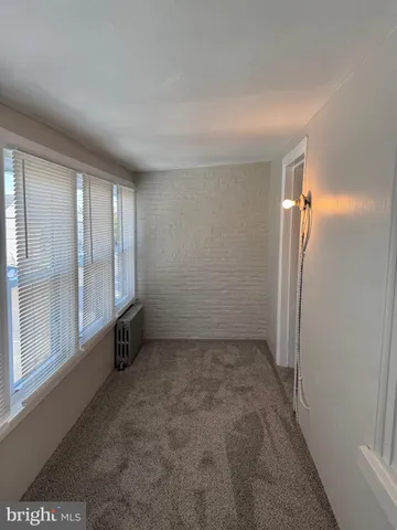 an empty room with a empty space and windows