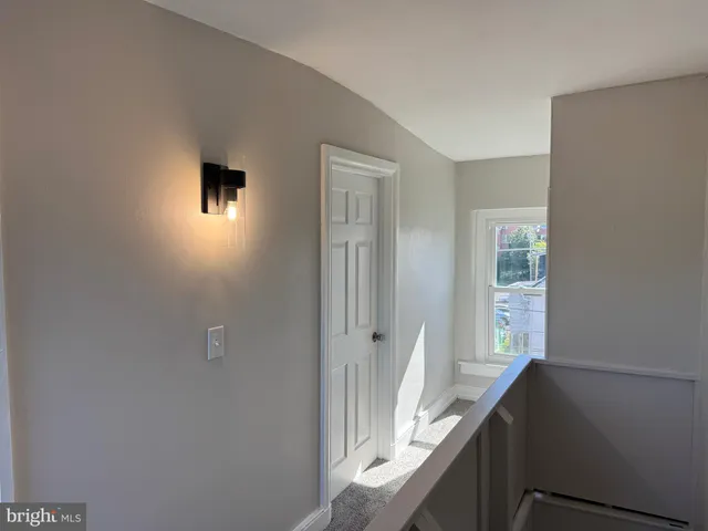 a view of hallway with wooden floor