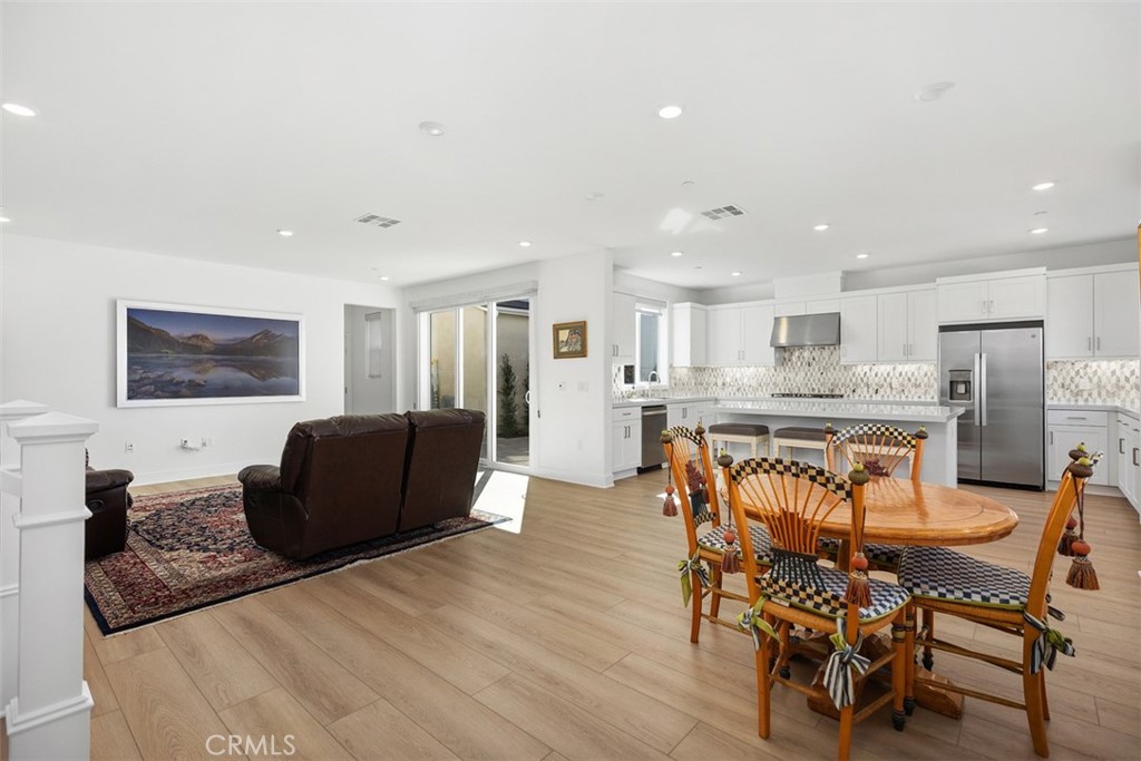 218 Sora Irvine, CA 92618 - Photo 14 of 65 a living room with stainless steel appliances kitchen island granite countertop furniture and a wooden floor