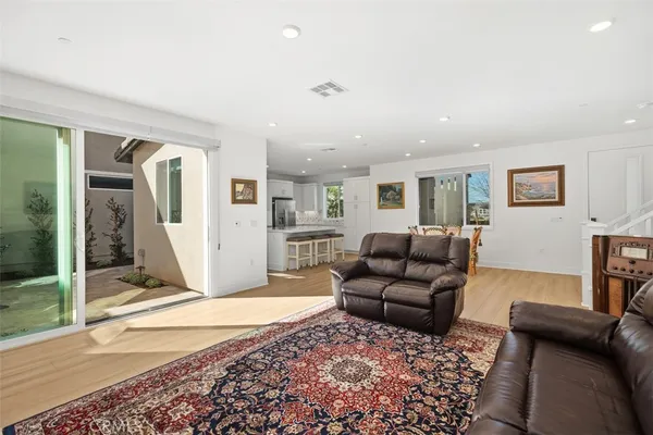 a kitchen with stainless steel appliances granite countertop a table chairs stove microwave and cabinets