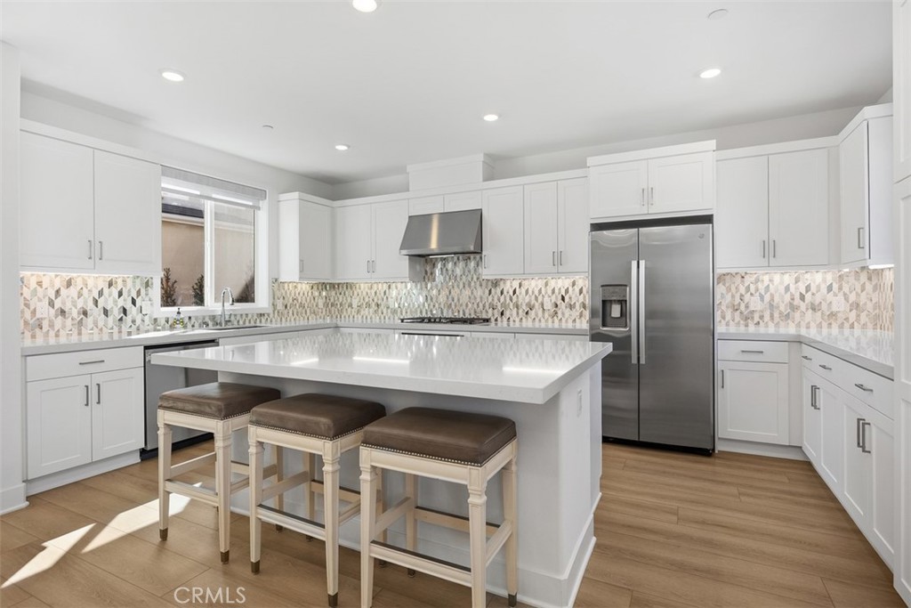 218 Sora Irvine, CA 92618 - Photo 24 of 65 a kitchen with stainless steel appliances granite countertop a table chairs stove microwave and cabinets