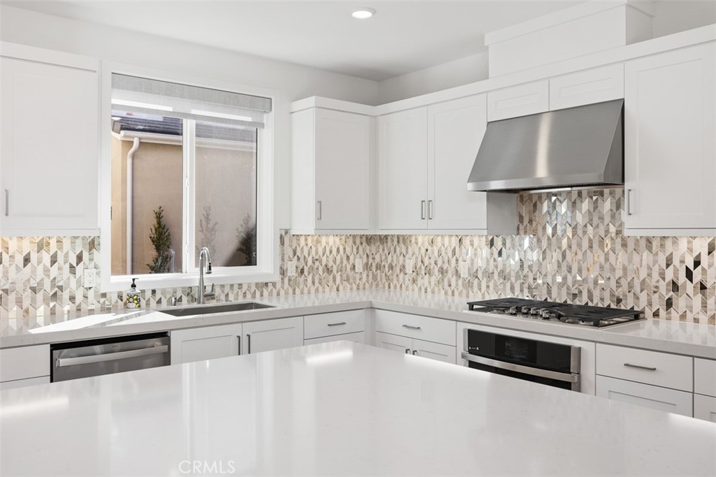 218 Sora Irvine, CA 92618 - Photo 25 of 65 a kitchen with stainless steel appliances a stove and white cabinets