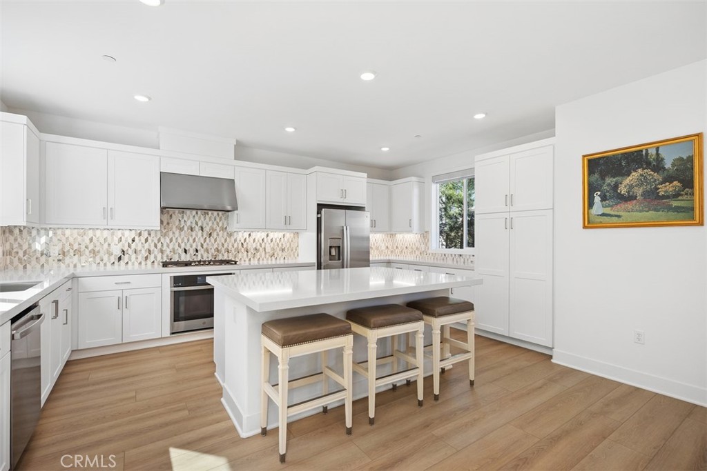218 Sora Irvine, CA 92618 - Photo 26 of 65 a kitchen with granite countertop white cabinets and stainless steel appliances
