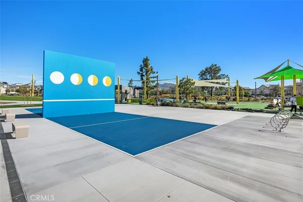 a row of palm trees in front of a building