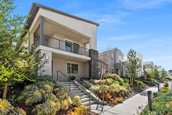 a living room with stainless steel appliances kitchen island granite countertop furniture and a wooden floor
