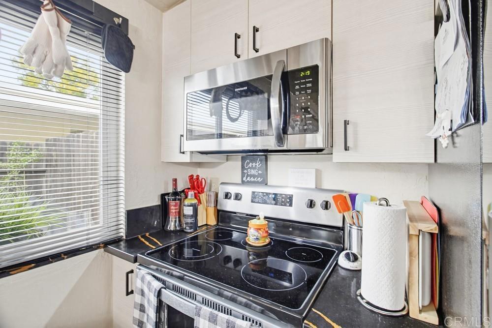 7861 Rancho Fanita Drive, Unit B Santee, CA 92071 - Photo 14 of 47 a kitchen with stainless steel appliances a stove and a microwave