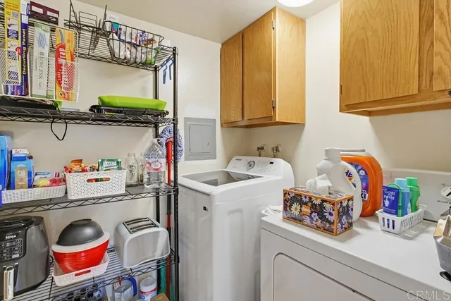 a utility room with a sink and cabinets
