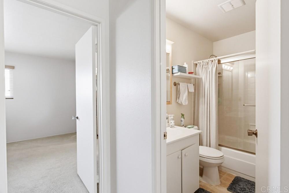 7861 Rancho Fanita Drive, Unit B Santee, CA 92071 - Photo 25 of 47 a bathroom with a granite countertop toilet a sink and a mirror