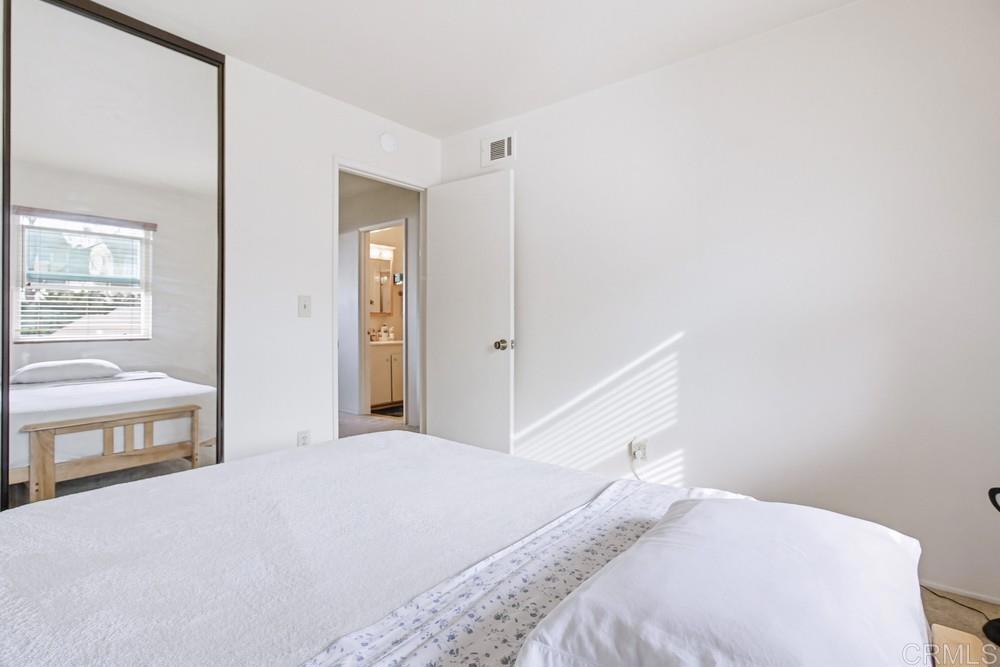 7861 Rancho Fanita Drive, Unit B Santee, CA 92071 - Photo 32 of 47 a bedroom with a large bed and a chandelier