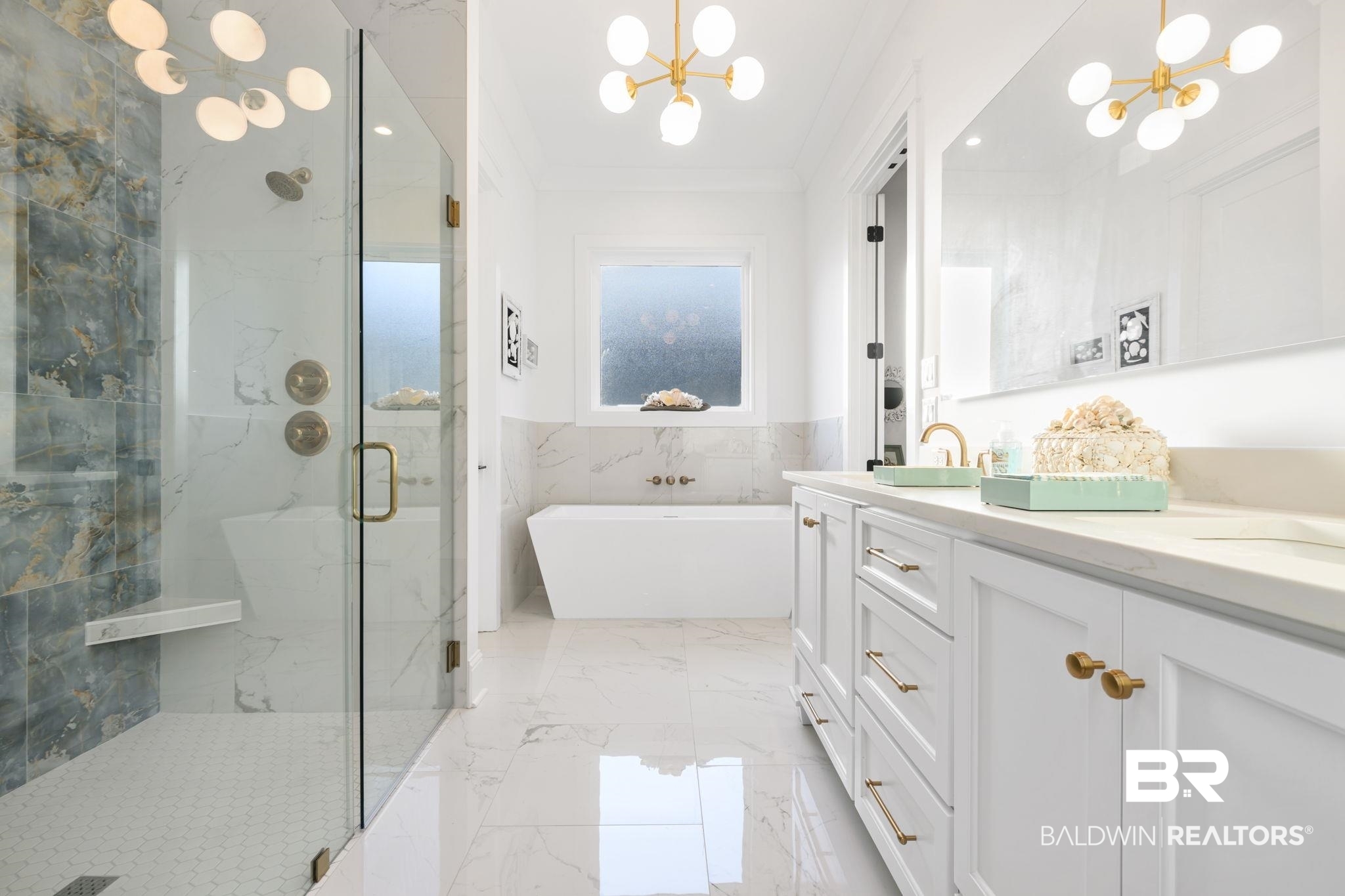 30313 River Road Orange Beach, AL 36561 - Photo 23 of 50 Bathroom featuring a chandelier, light marble finish floors, a marble finish shower, double vanity, and crown molding